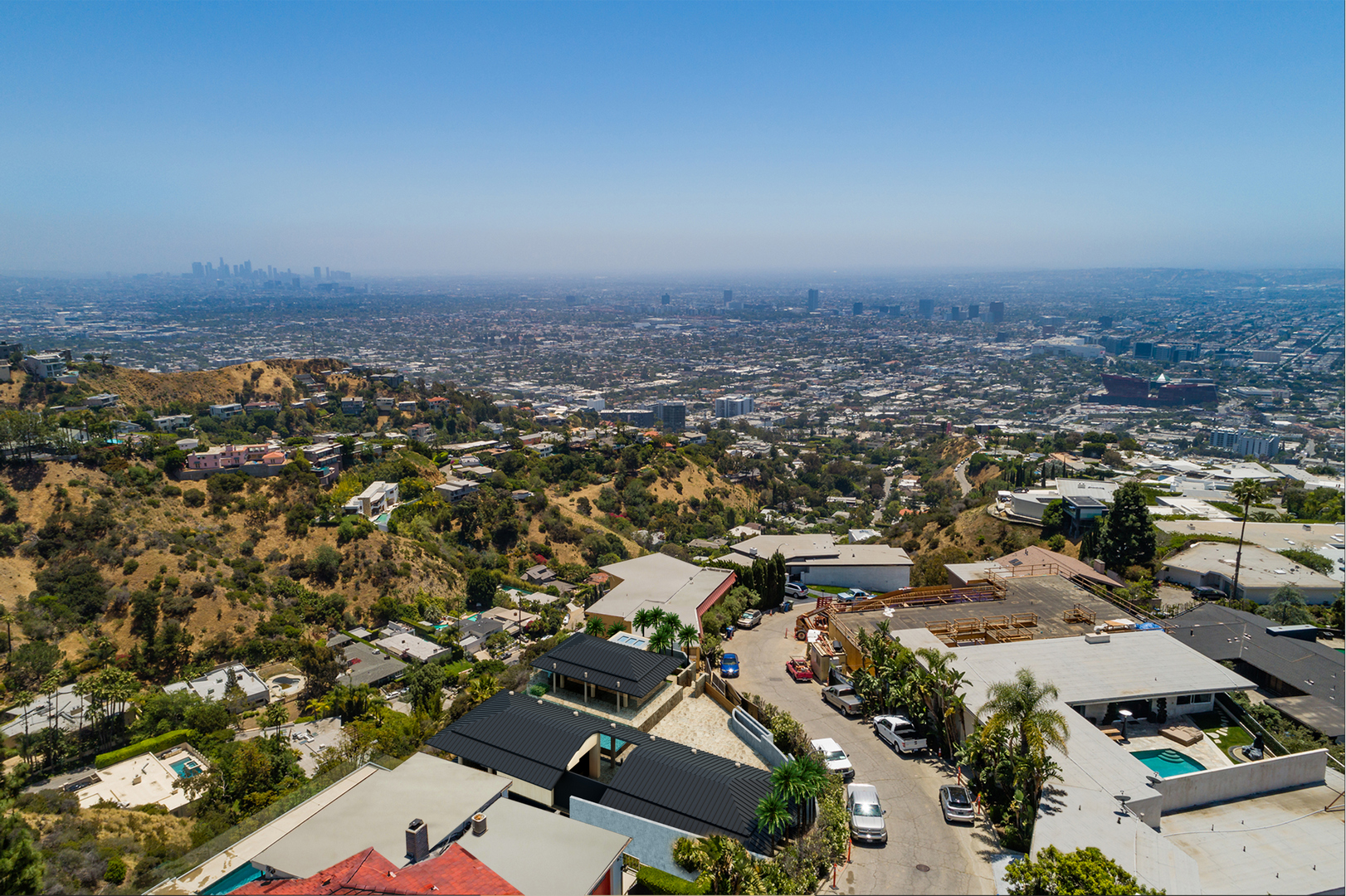 Hollywood Hills property aerial drone view showing hillside position, luxury real estate visualization by Rendimension